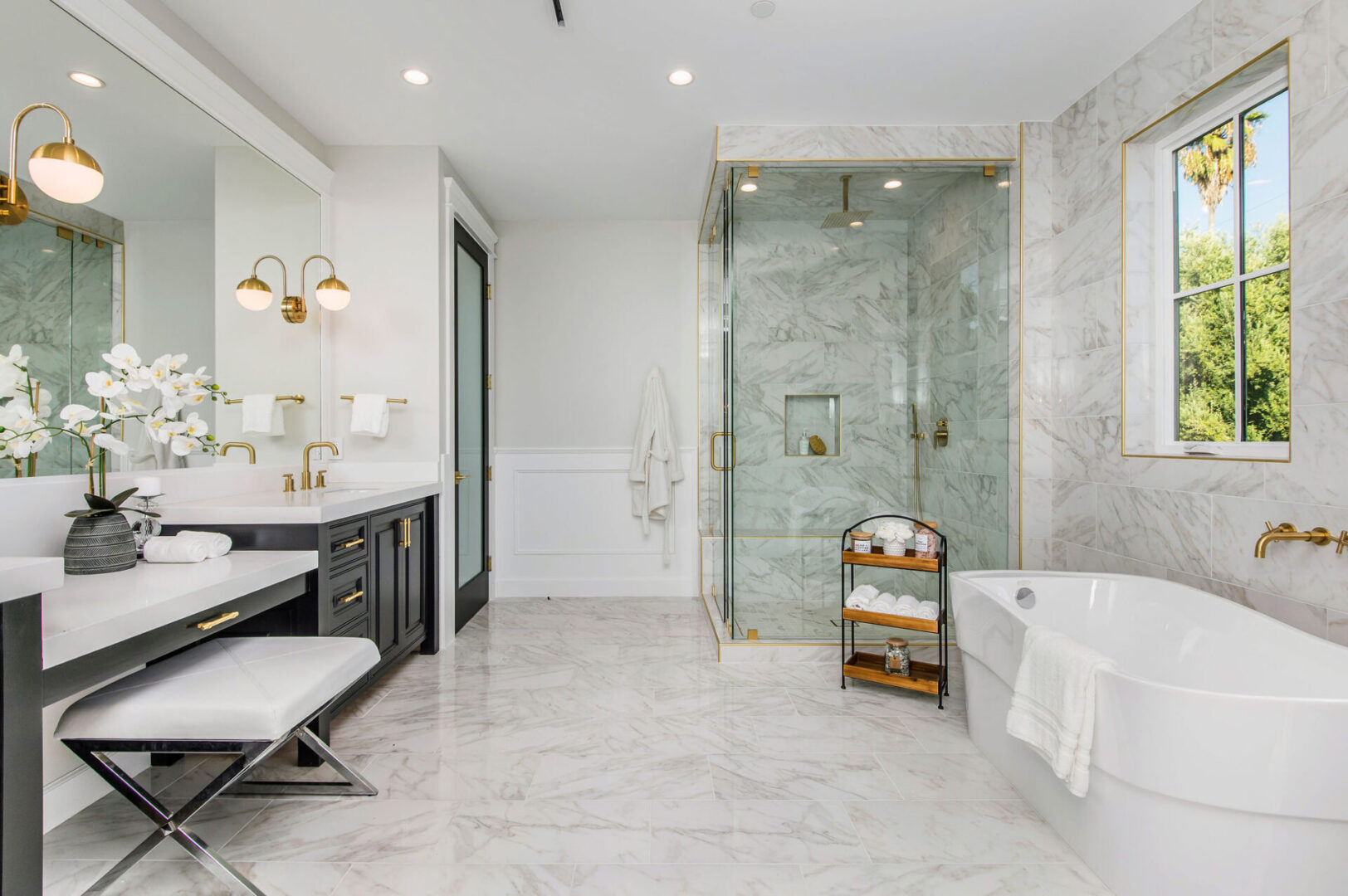 A Full Marble Bathroom With Black Cabinets