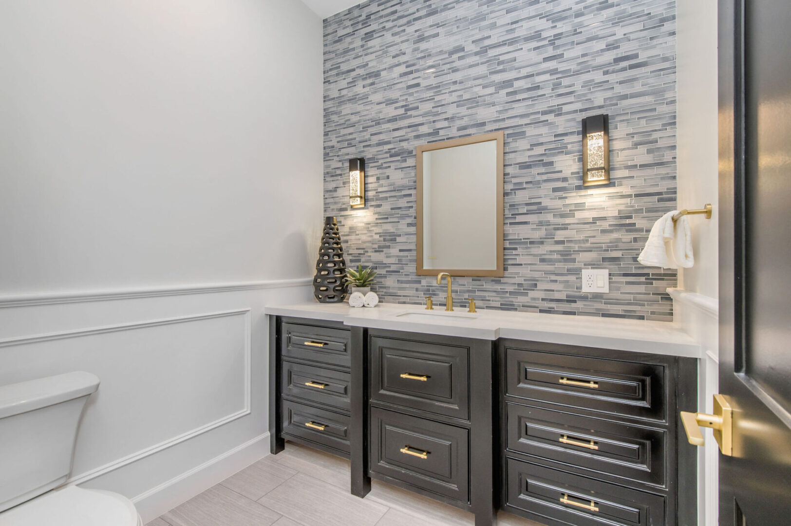 A Brass Frame Mirror With a Dark Wood Color Cabinet