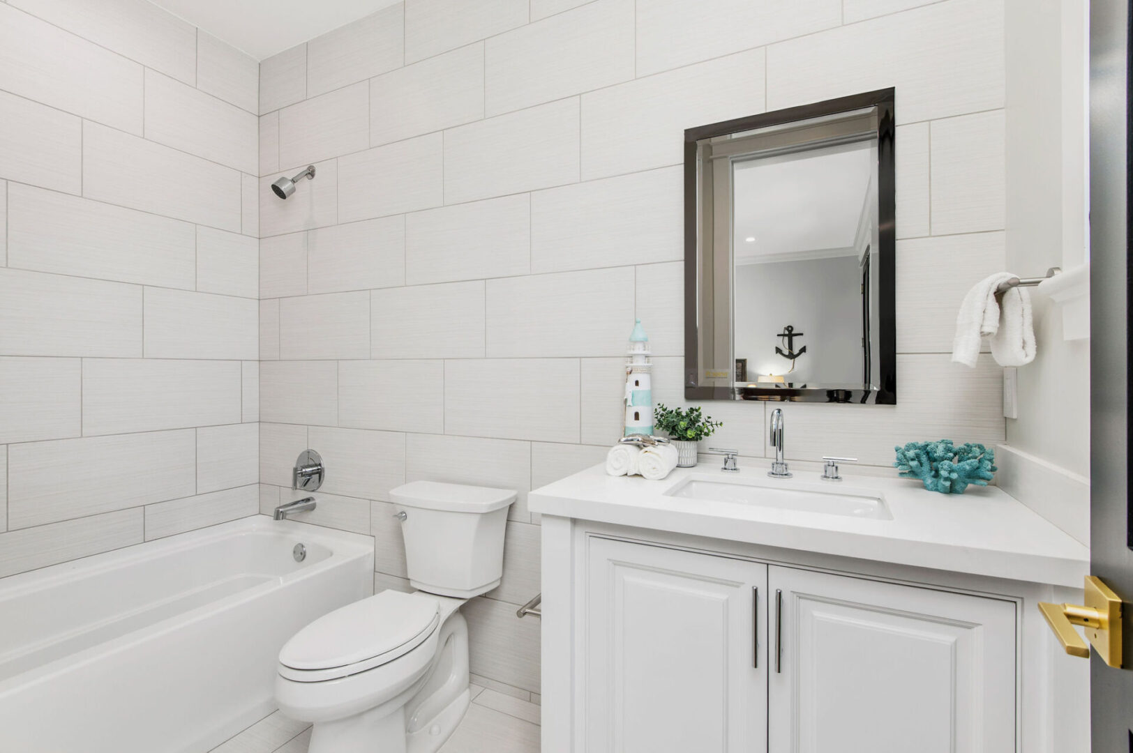 A Bathroom Space With a Black Frame Mirror