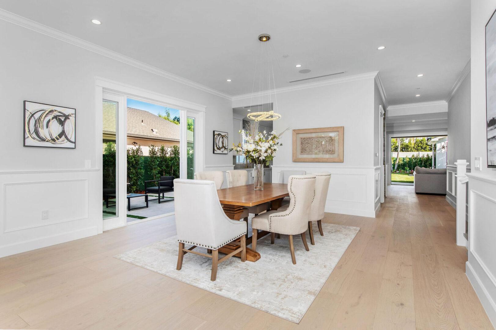 A Dining Room With White Carpet and Chairs