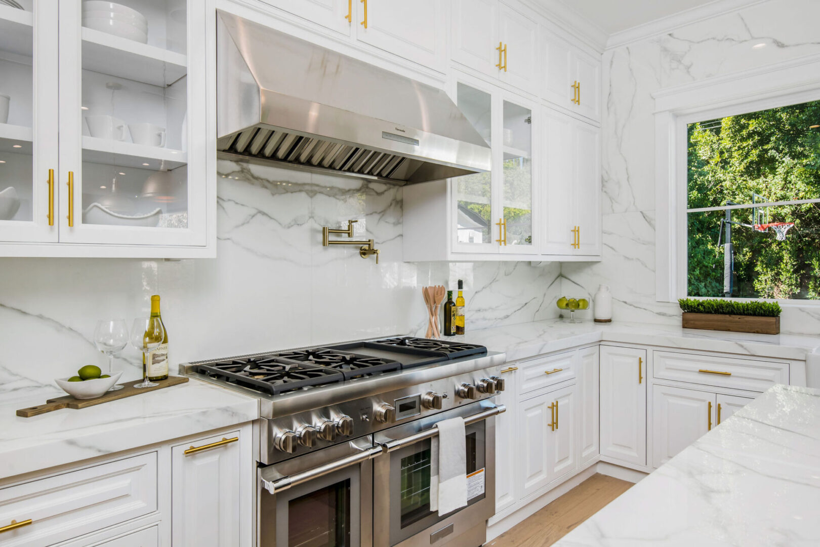 A kitchen with white and gold details