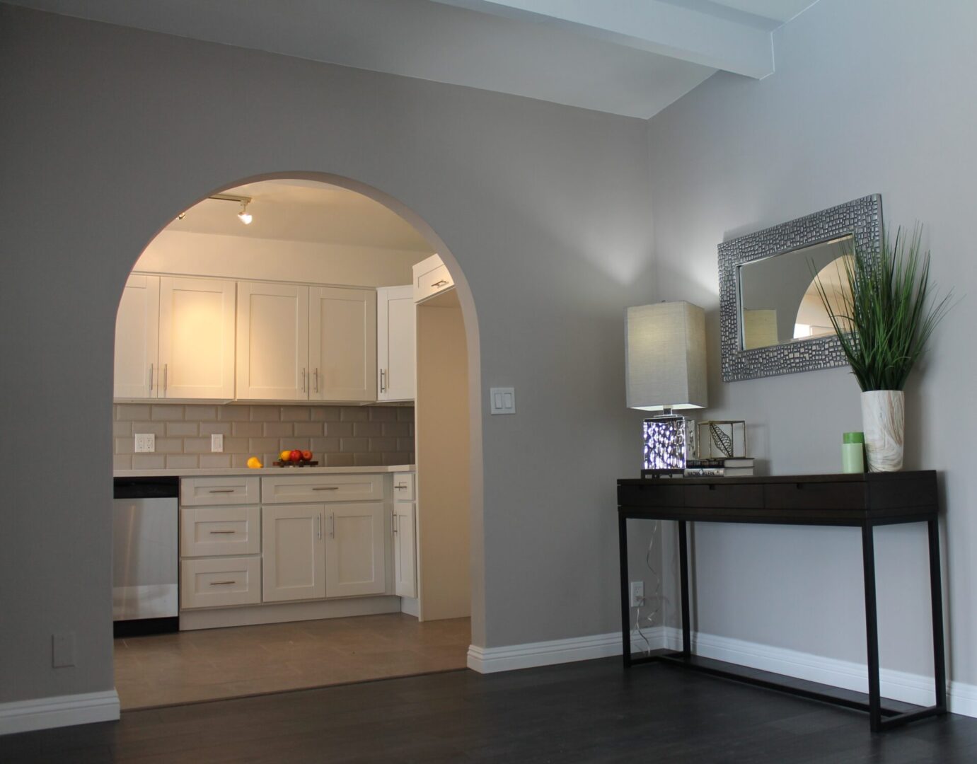 An Arch to a Plane White Kitchen