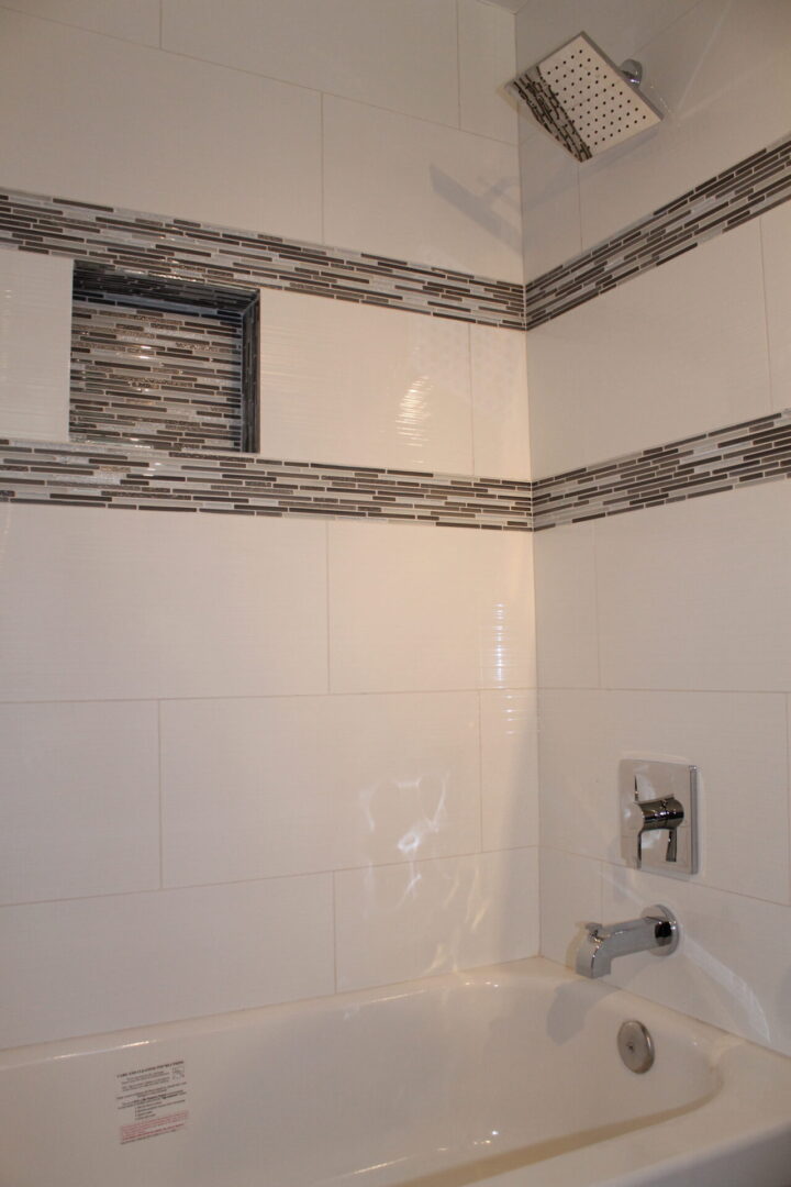 A White Walled Bathroom With Tubs