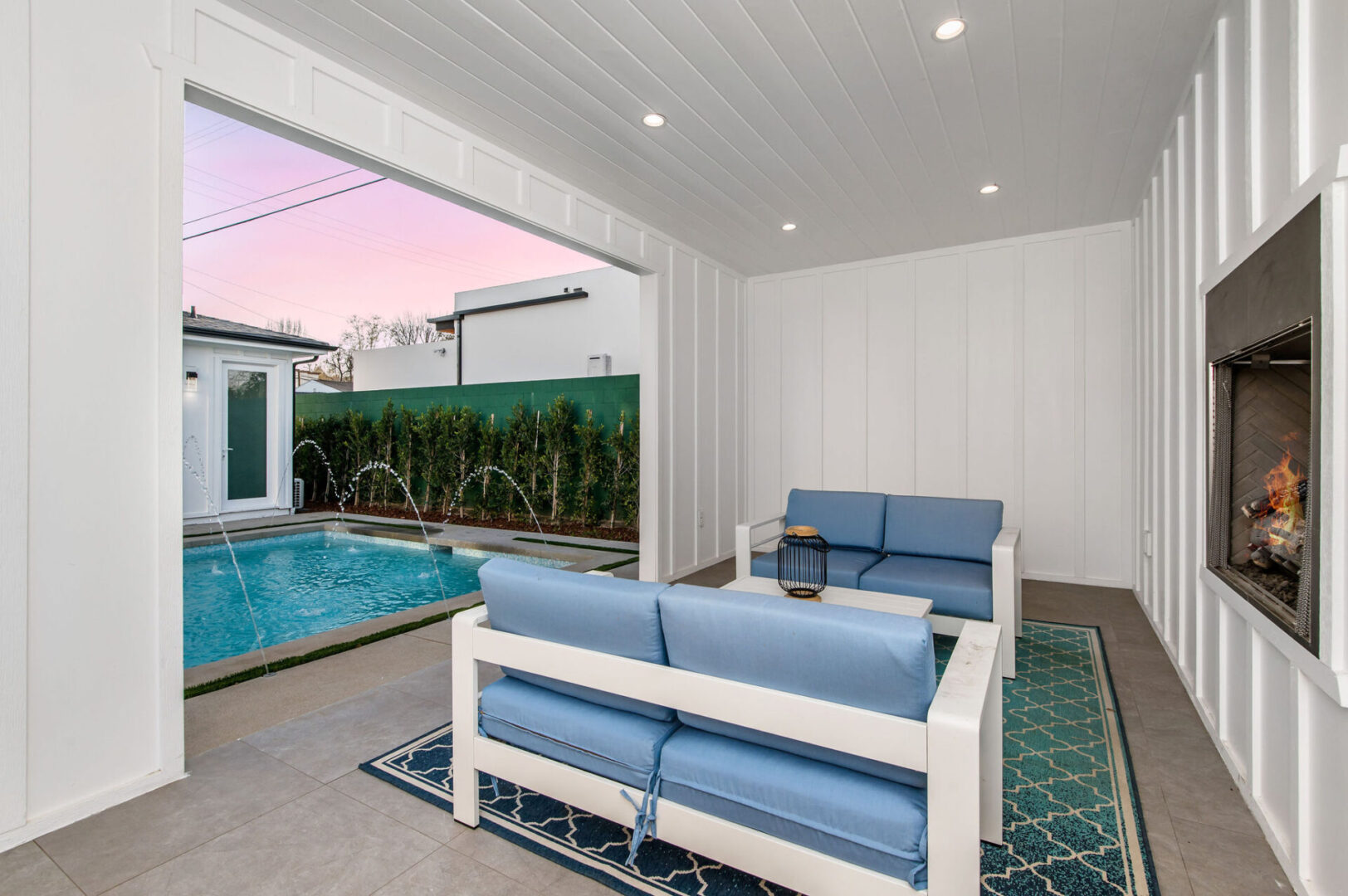 A White Color Wood Sofa With Blue Cushions by a Pool