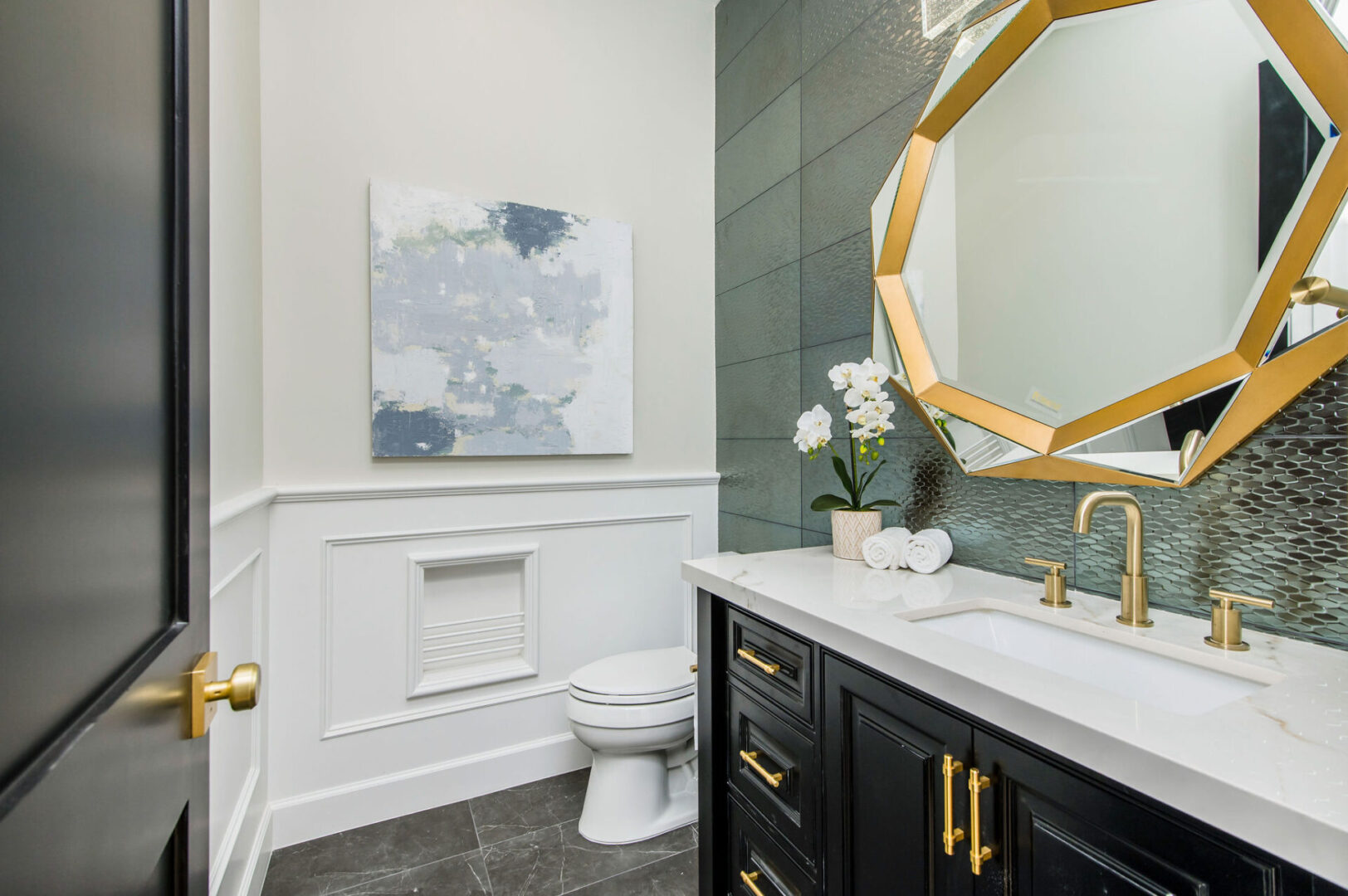 A Bathroom With White Counter With Brass Fitting