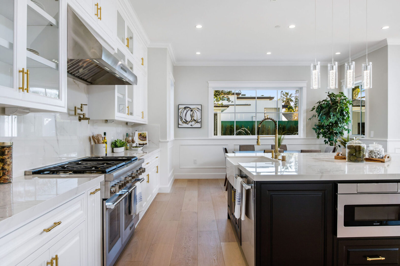 A White Color Kitchen Cabinet With Brass Handles