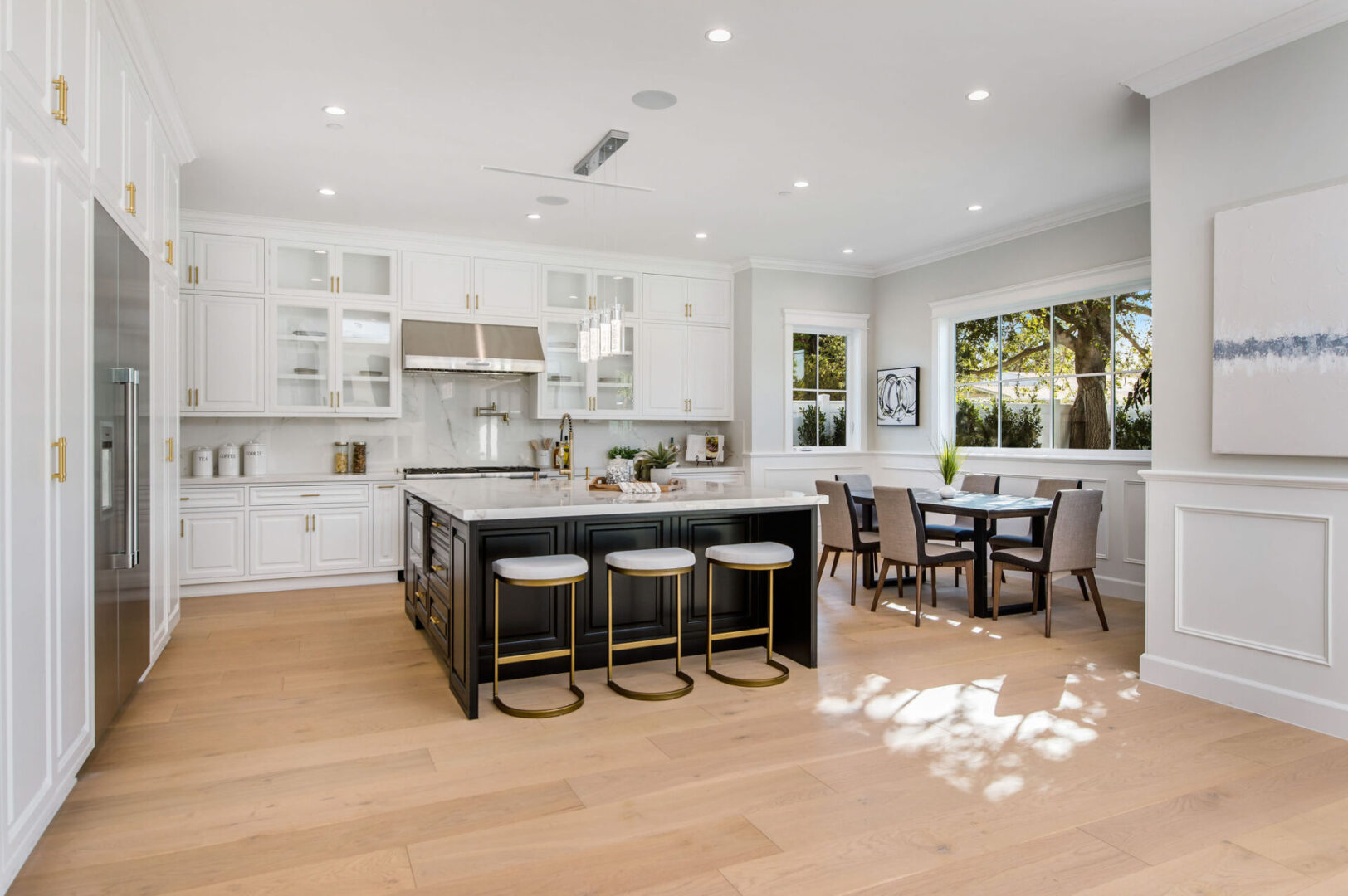 A White Color Themed Kitchen With Wood Island