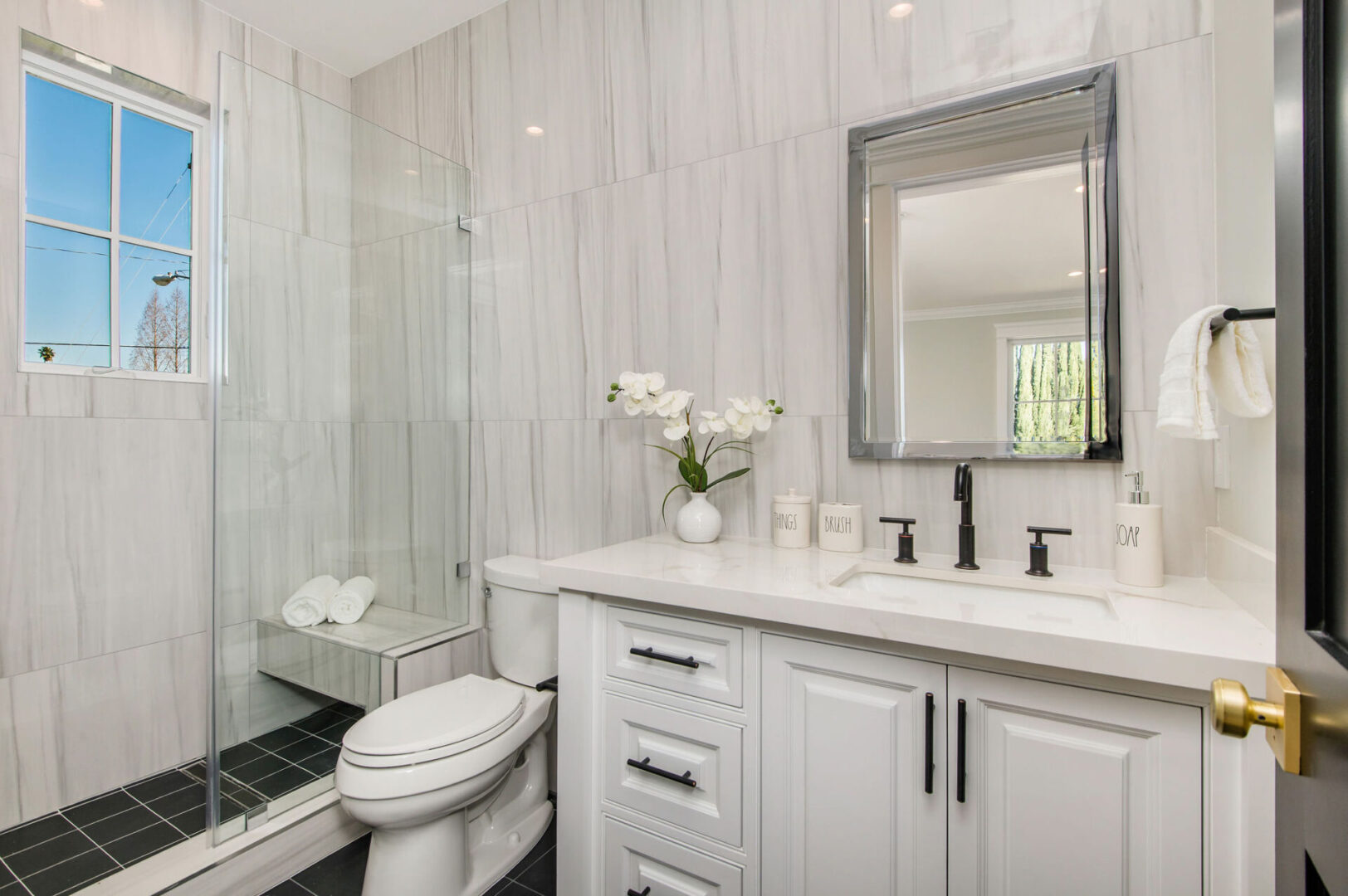 A Marble Walled Bathroom With Black Color Tiles